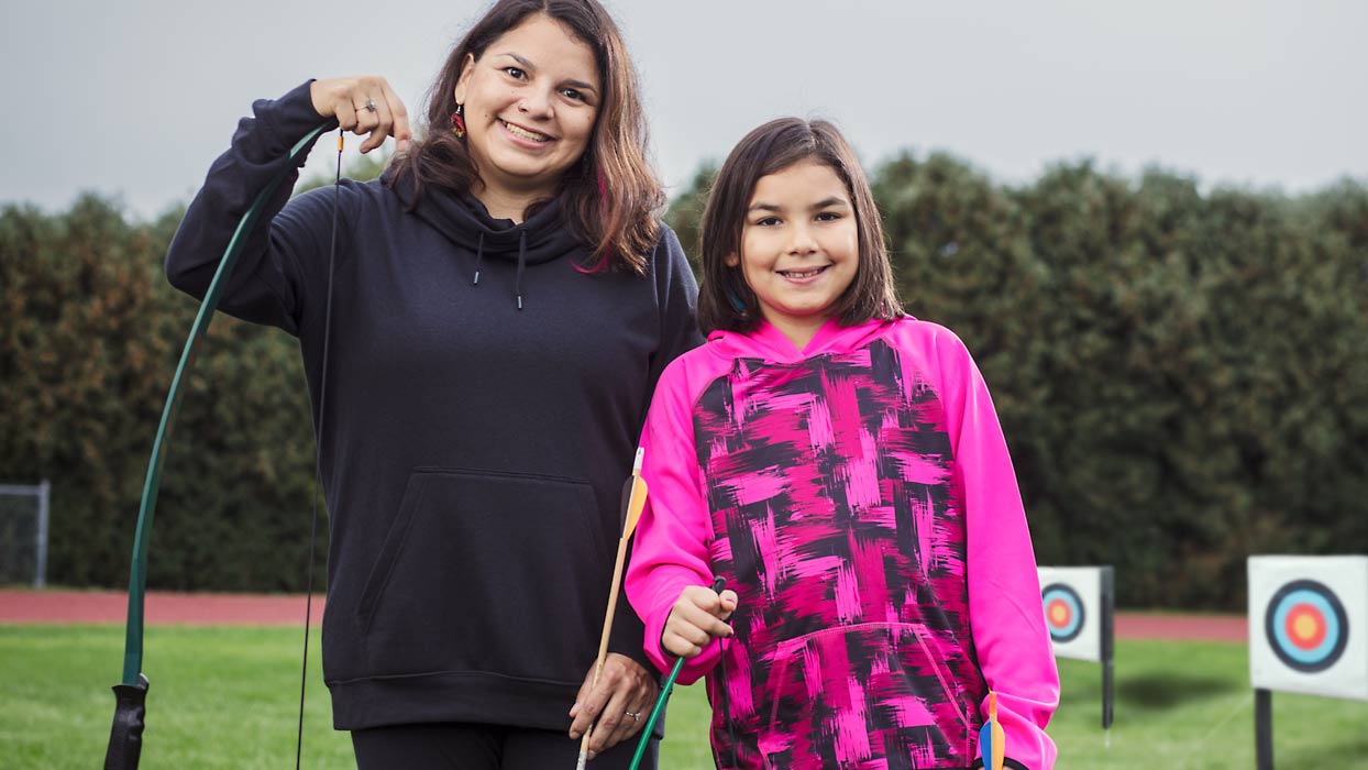 Mother with daughter at archery