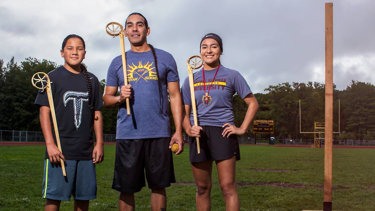 Father with children on lacrosse field